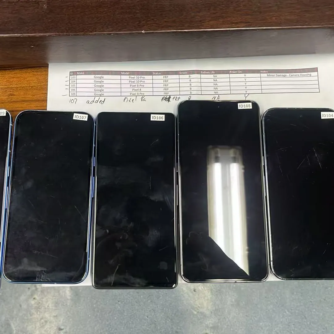 Graded Google Pixel smartphones lined up beside a printed grading sheet
