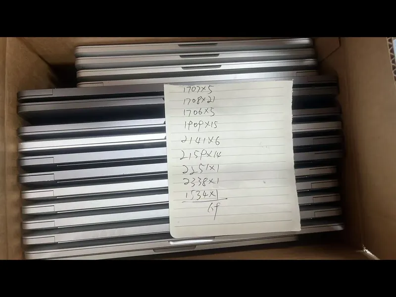 A boxed MacBook Pro lot with a handwritten model count sheet